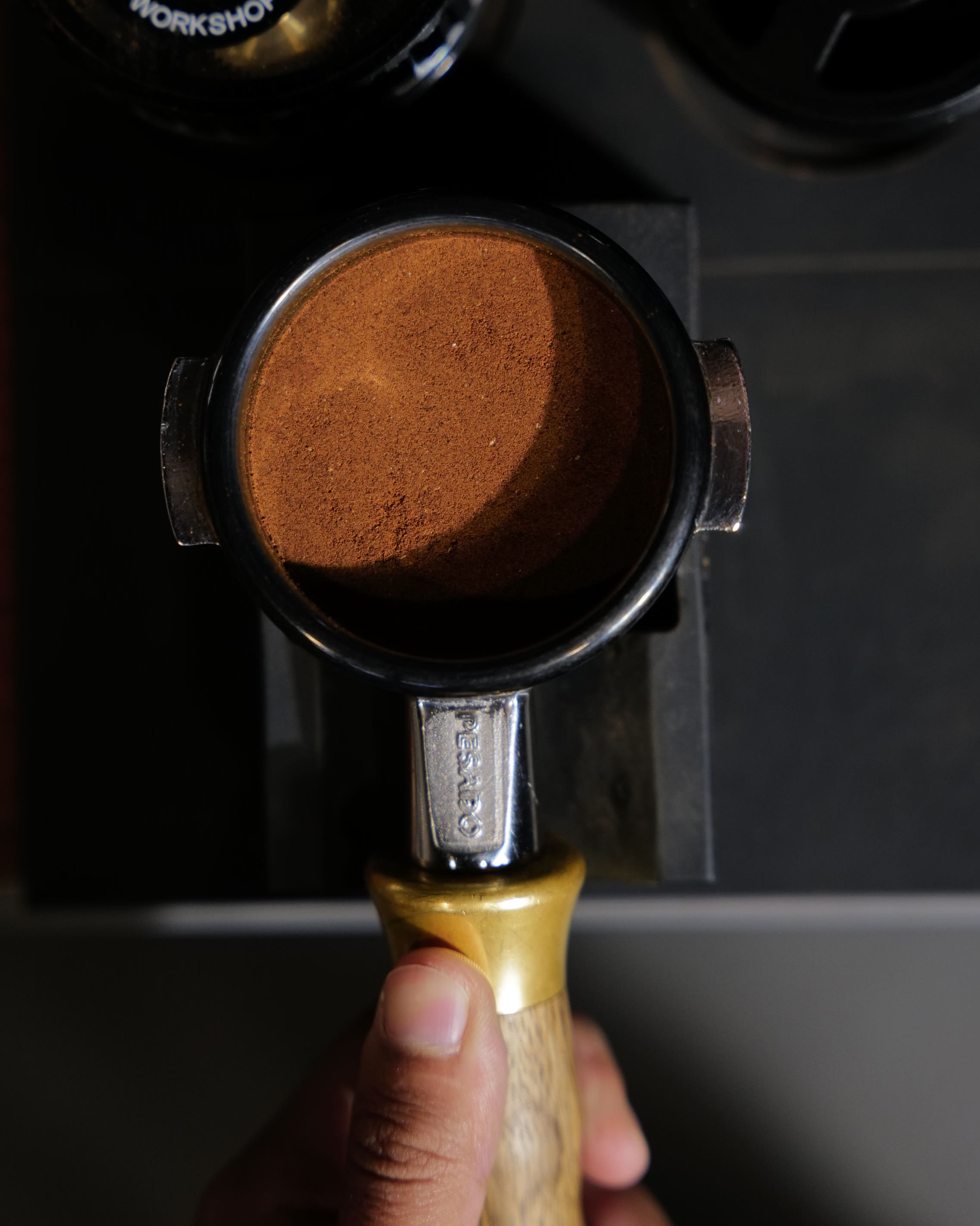 Top-down view of tamped espresso puck ready for extraction