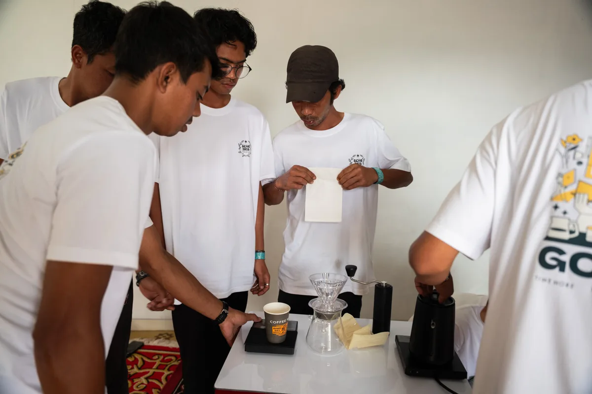 GCAG Indonesia participants practising with coffee brewing equipment together.